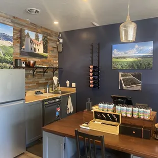 a wine tasting room with a refrigerator and table