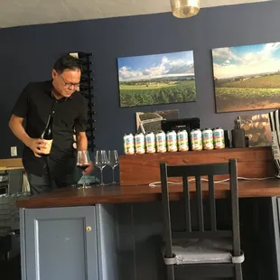 a man pouring a glass of wine