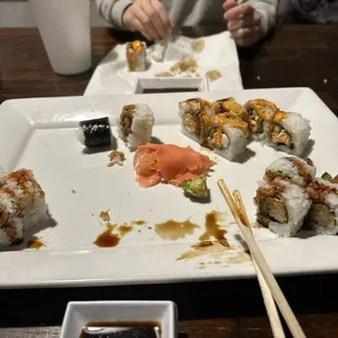 a person eating sushi with chopsticks
