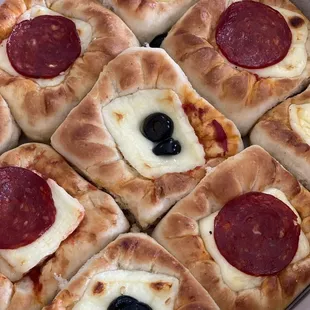a pizza with pepperoni and olives
