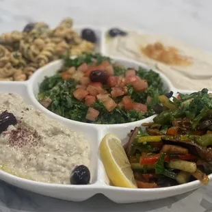 Salad Tray with baba ghanouj, hummus, eggplant salad, pasta salad, and tabbouleh