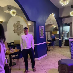 a man and a woman standing in a restaurant