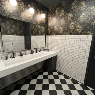 Bathroom Sink has fancy hand dryers