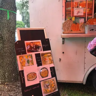 a woman selling food from a food truck