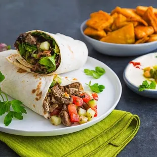 two burritos and a bowl of chips