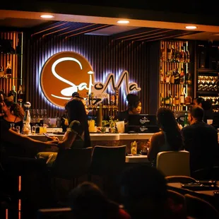 a group of people sitting at a bar