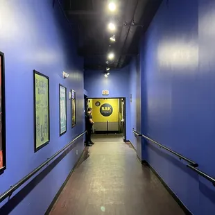 a man walking down a hallway