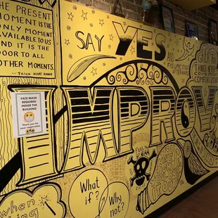 a yellow wall with graffiti