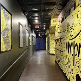 a long hallway with graffiti on the walls