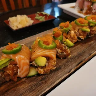 a variety of sushi on a wooden board