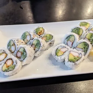 a plate of sushi and french fries
