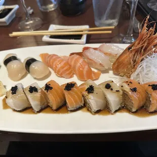 Scallop , salmon belly and sweet shrimp nigiri. Pirate roll at the bottom.