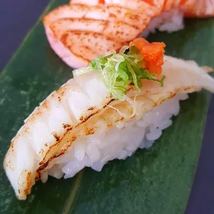 a variety of sushi on a leaf