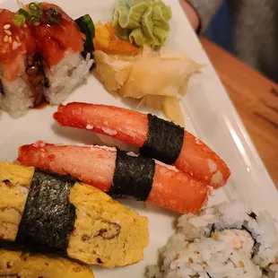 a plate of sushi and rolls