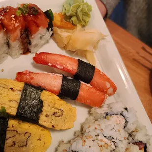 a plate of sushi and rolls