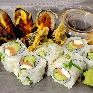 a tray of sushi with a variety of toppings