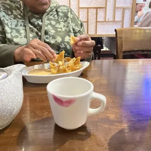 a woman sitting at a table with a plate of food