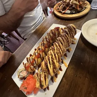 people eating sushi at a restaurant