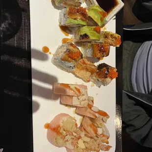 a plate of sushi and rolls