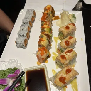 a plate of sushi rolls and sauce