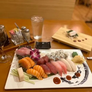 a plate of sushi and a glass of wine