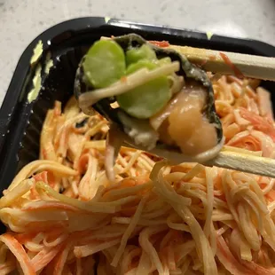 a plate of noodles with chopsticks
