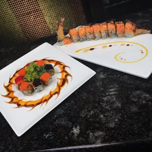 a plate of sushi and a plate of rolls