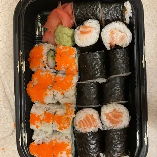 a tray of sushi and rolls