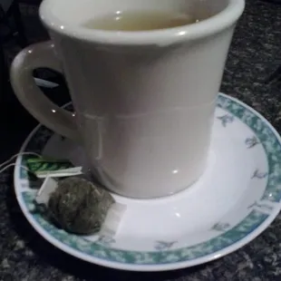 Green Tea is served as mug of hot water with s tea bag