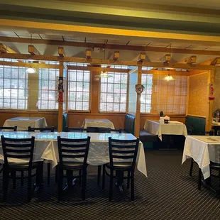 tables and chairs with white tablecloths
