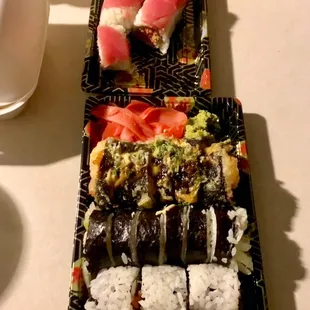 a plate of sushi and rolls