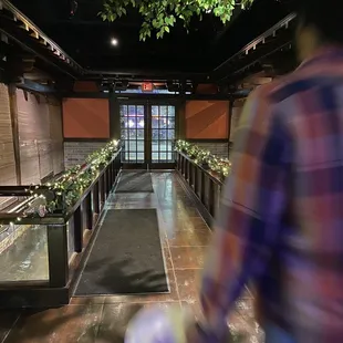 a blurry image of a man walking down a hallway