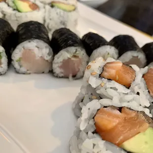 a variety of sushi rolls on a plate