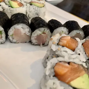 a variety of sushi rolls on a plate