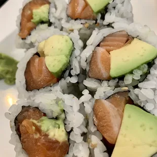 four pieces of sushi with avocado