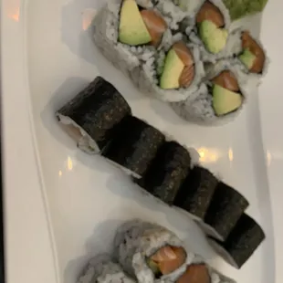 two pieces of sushi on a white plate