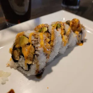 a piece of sushi on a white plate