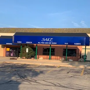 the outside of a building with a blue awning