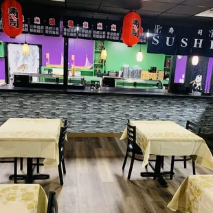 the interior of a restaurant with tables and chairs