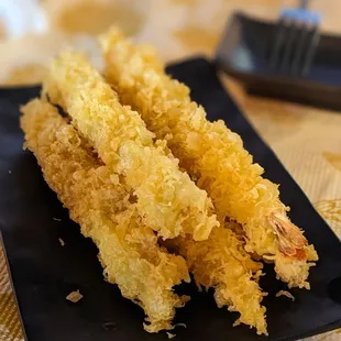 a plate of deep fried shrimp sticks