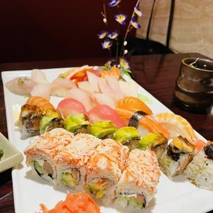 a variety of sushi on a white plate