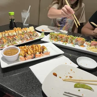 a woman eating sushi with chopsticks