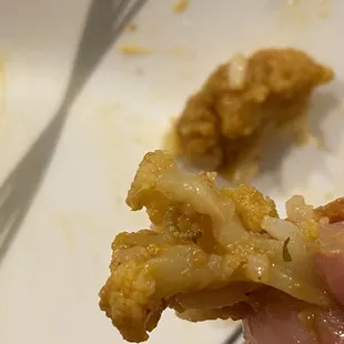 a hand holding a piece of food