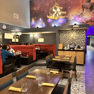 a woman sitting at a table in a restaurant