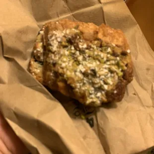 Blurry pic of a chocolate pistachio croissant.