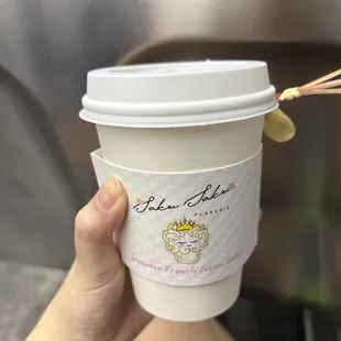 a person holding a cup of coffee