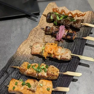 BOTTOM TO TOP: yakitori: salmon, tuna, chicken, pork belly, ribeye