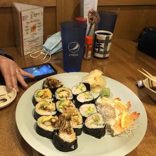 a plate of sushi and a phone