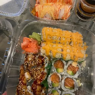 a tray of sushi and rolls