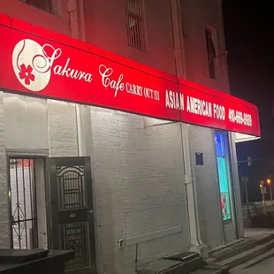 the front of the restaurant at night